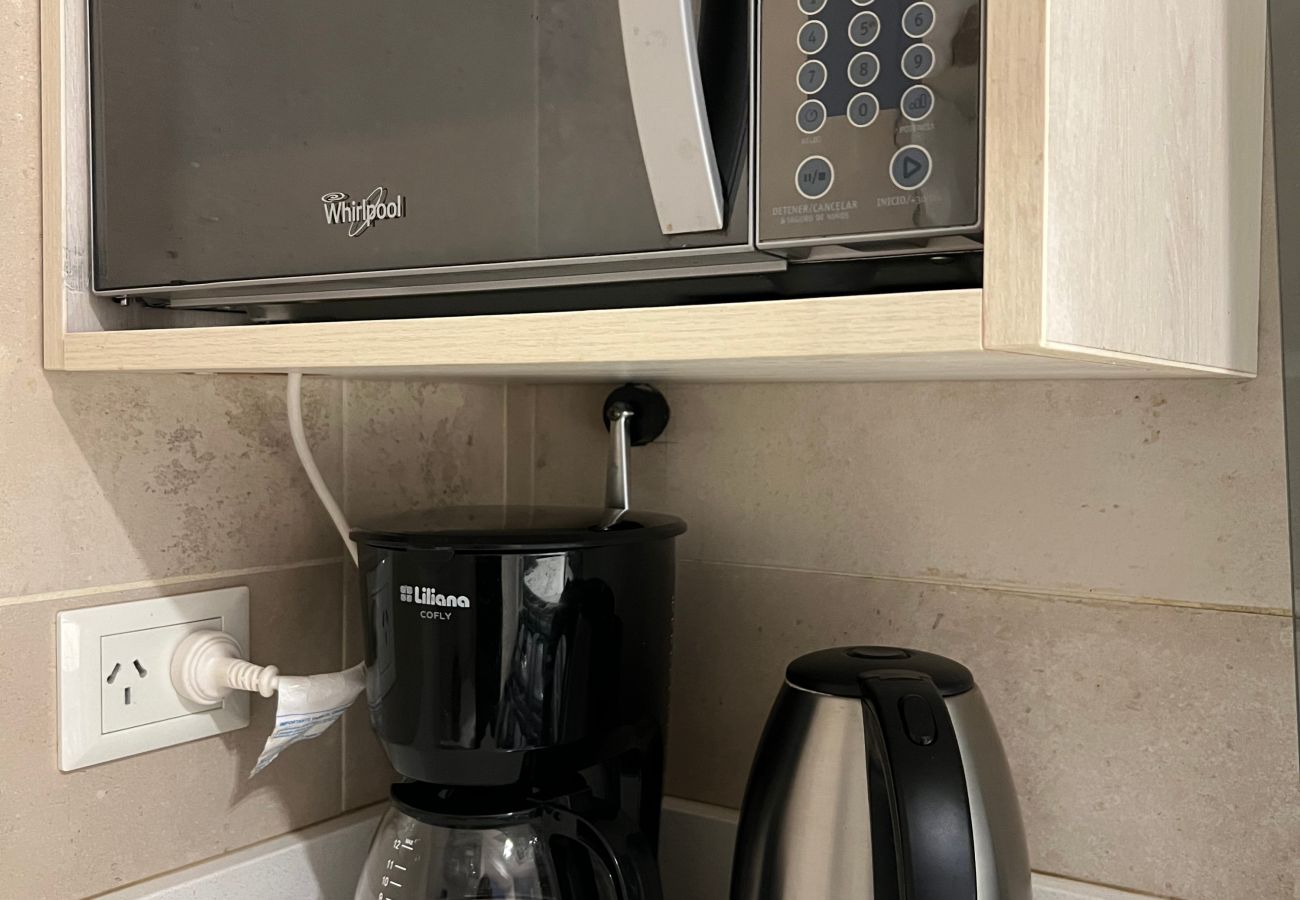 Kitchen detail in Arrayán -1A apartment with microwave, electric kettle, and drip coffee maker.