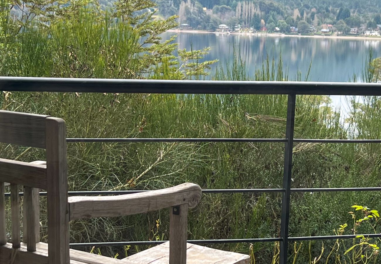 Detail of the balcony in Arrayán 1A apartment with outdoor furniture and panoramic lake views.